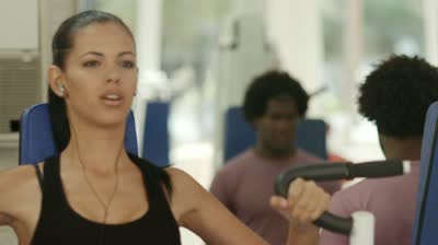 stock-footage-sports-activity-young-man-and-woman-exercising-and-working-out-in-wellness-gym-rack-focus