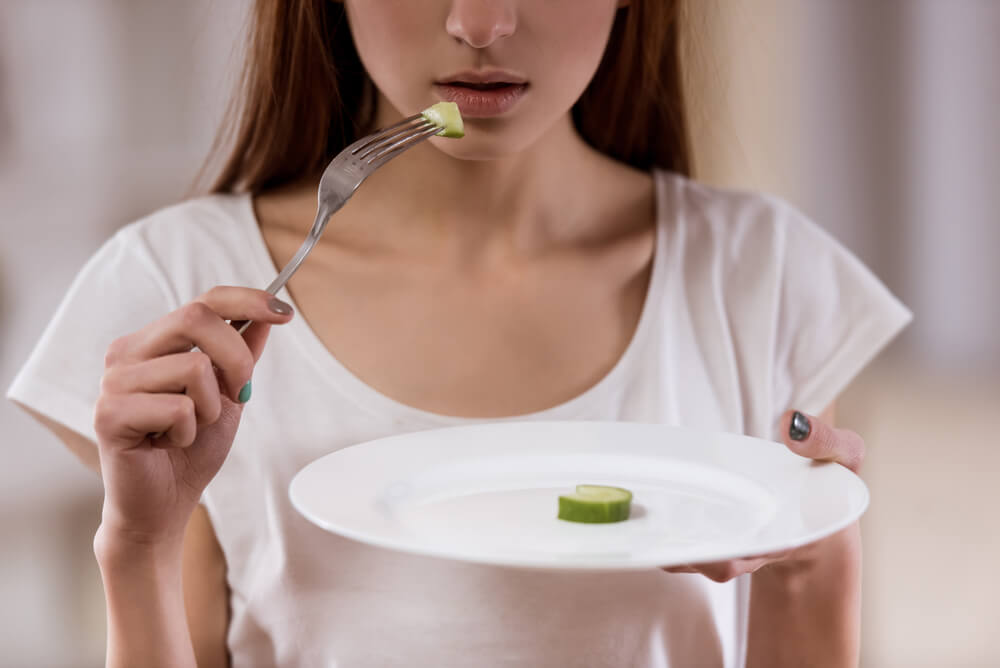 girl eating cucumber 