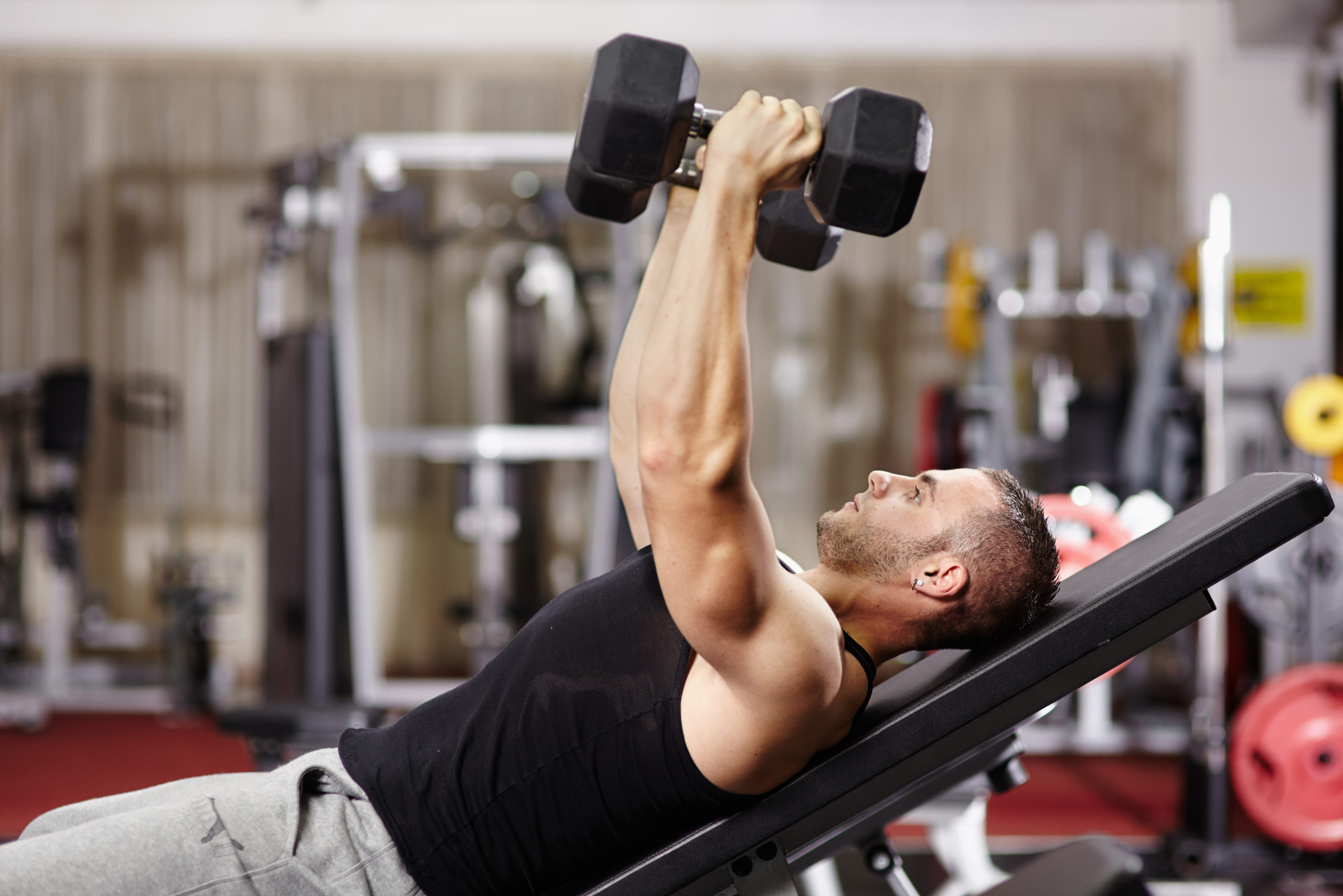 man working out incline dumbbell press